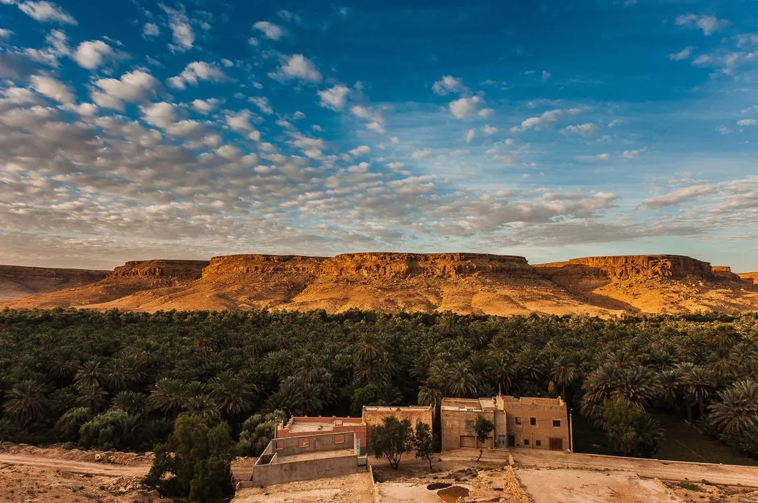An earthen kasbah above the palm groves of the Draa Valley
